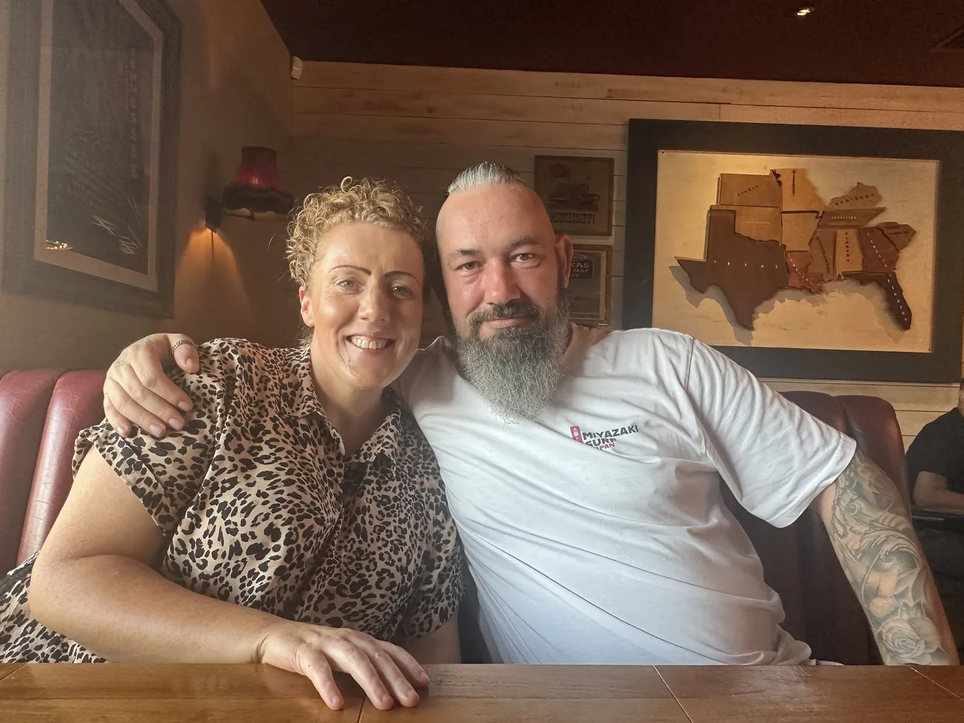 Nicky and Vicky Stokes sitting together in a restaurant booth, smiling