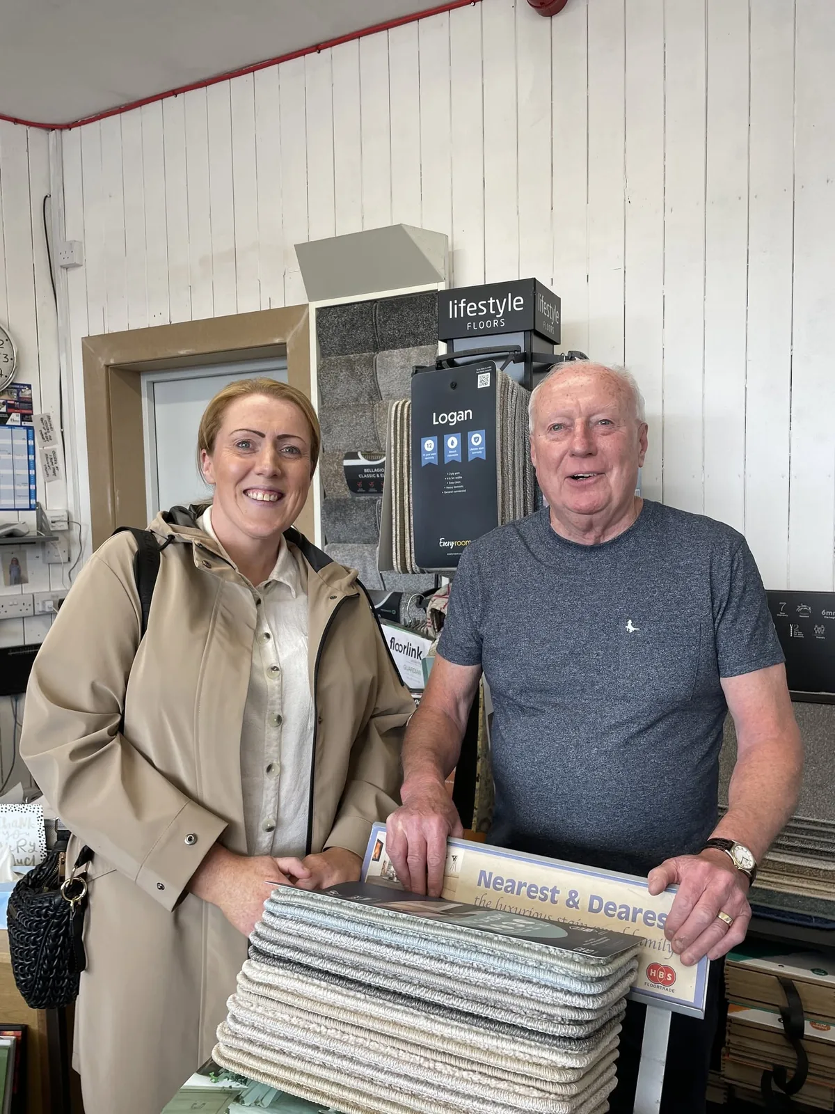 Vicky Stokes with Tony holding carpet samples in the Sandal Carpets shop